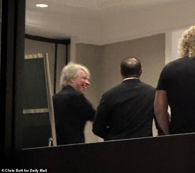 Jon Bon Jovi and Tiger Woods share a laugh on their way into the party on Wednesday