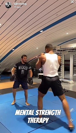The heavyweight boxer was seen hitting pads in what he called 'mental strength therapy'