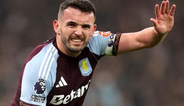 John McGinn calls for help after injuring his knee during Aston Villa's defeat to Everton