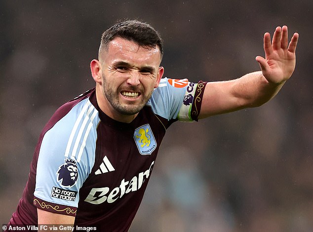 John McGinn calls for help after injuring his knee during Aston Villa's defeat to Everton