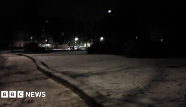 Tracks and footprints on the surface of a frozen lake at night