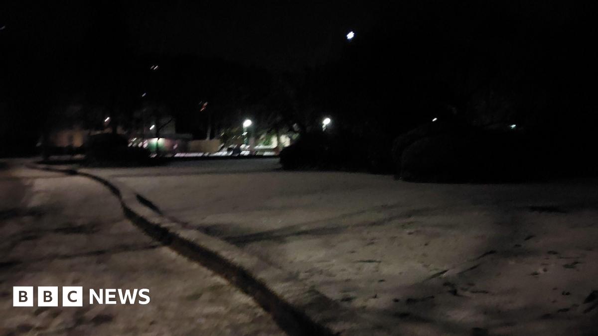 Tracks and footprints on the surface of a frozen lake at night
