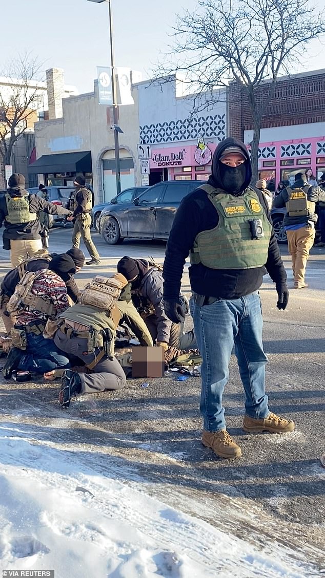 Border Force agents with nurse Alex Pretti after he was shot in Minneapolis