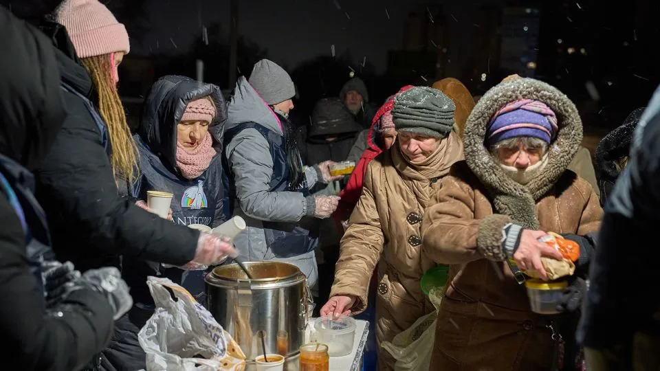 Saint'Egidio Christian community volunteers give out free hot meals to elderly people in Kyiv, Ukraine, on January 23. - Efrem Lukatsky/AP