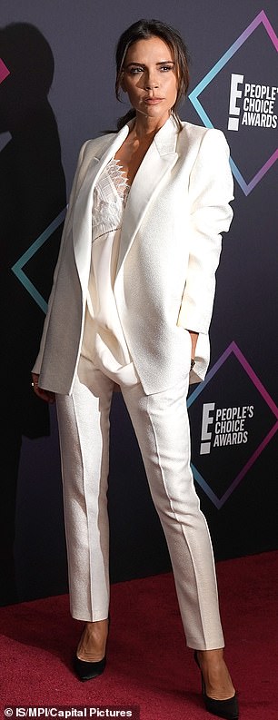 Victoria Beckham also wears a white tuxedo and a power stance