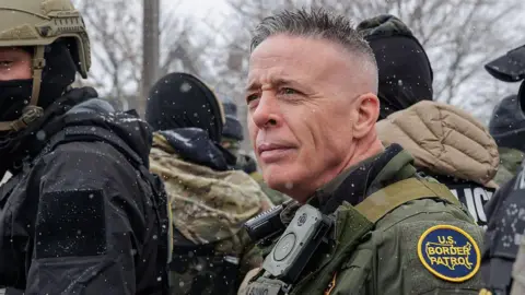 Getty Images Gregory Bovino alongside border patrol officers in Minneapolis in January 2026. 