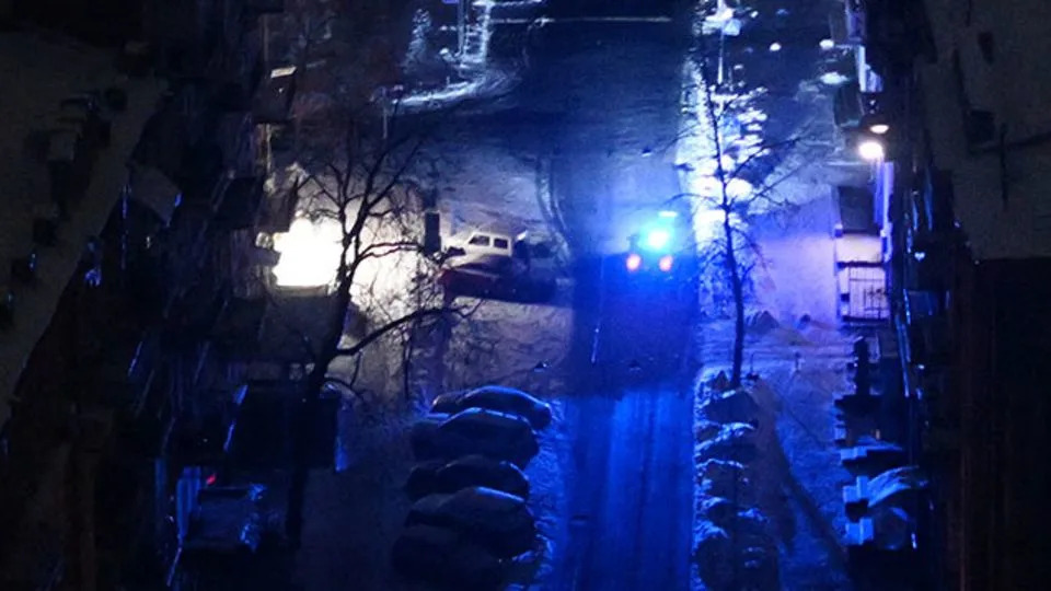 A police vehicle drives along a dark street during a power outage a few hours after an air attack began in central Kyiv, Ukraine, on January 24. - Sergei Gapon/AFP/Getty Images
