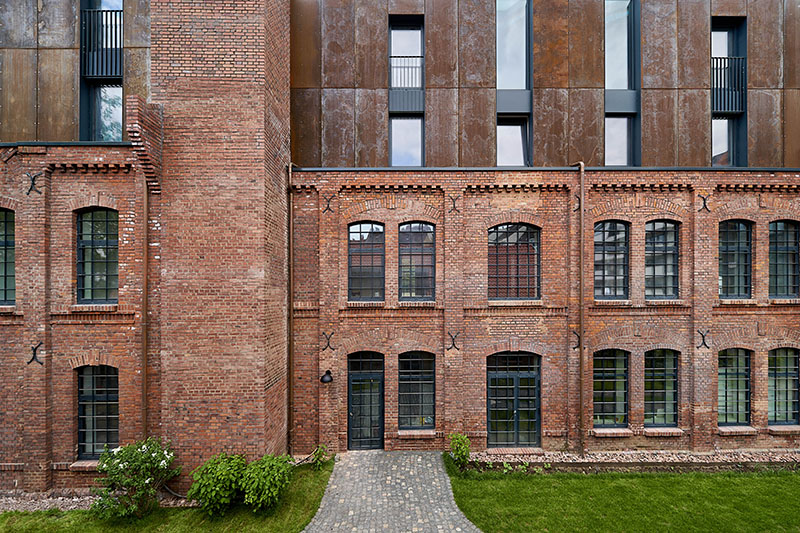 corten steel extends former laundry complex’s brick buildings in kassel