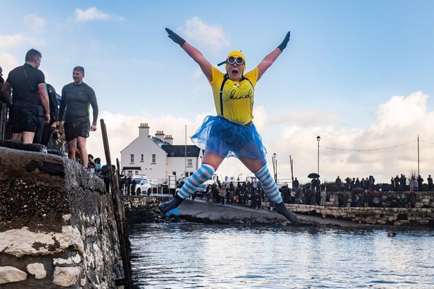 Hundreds brave icy waters in Carnlough for charity on New Year's Day