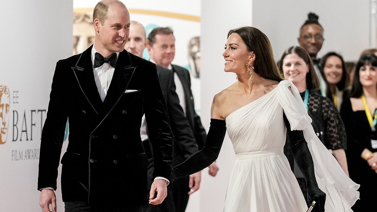 Prince William smiles after Kate Middleton pats his behind at BAFTAs