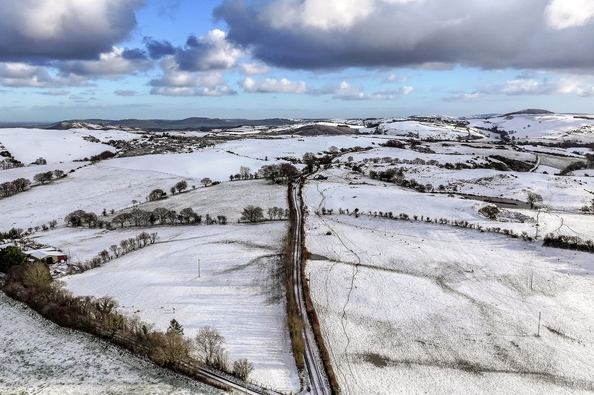 In this aerial view, near Llanrwst, snow covers the high ground of North Wales and Snowdonia