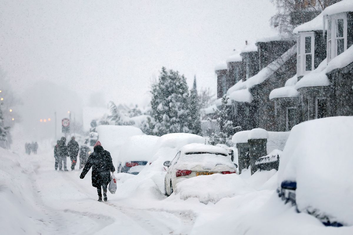 People walk in Main Street Alford as Aberdeenshire Council declared a "major incident" as snow continues on January 06, 2026 Alford, Scotland