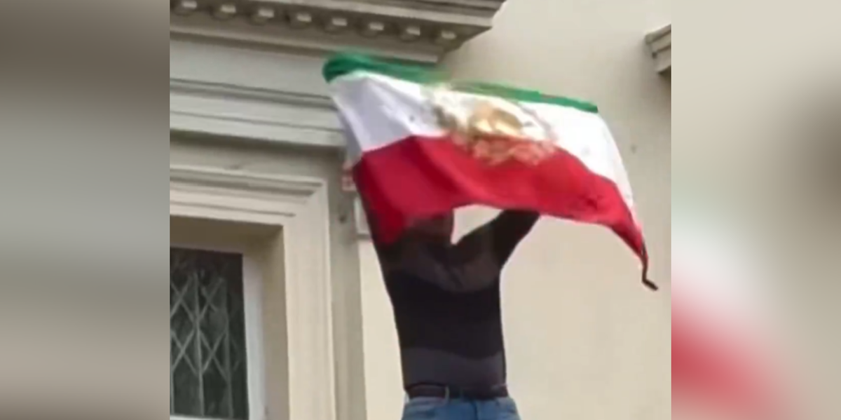 Protester rips flag off Iranian Embassy in London as demonstrations reach Britain