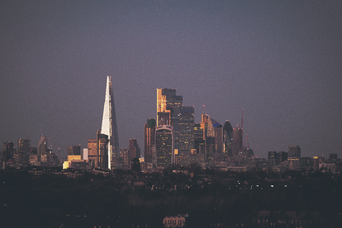 City of London skyline with modern skyscrapers under a clear blue sky, showcasing iconic financial district architecture
