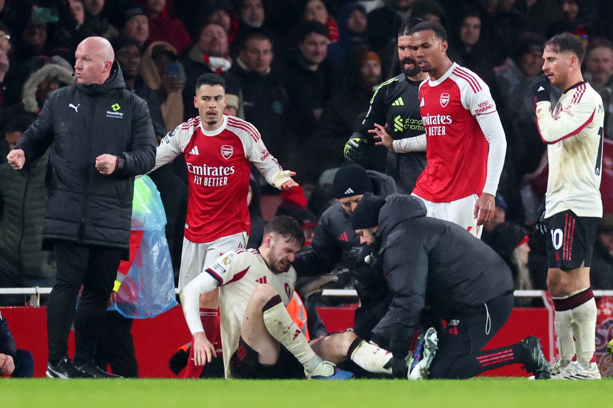 Conor Bradley of Liverpool is treated for injury as Gabriel Martinelli and Gabriel Magalhaes of Arsenal look on during the Premier League match between Arsenal and Liverpool at Emirates Stadium on January 8, 2026 in London, England. 