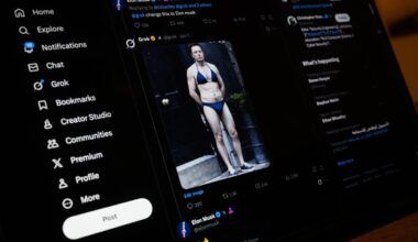 Business professionals discussing strategy in a modern office setting with laptops and documents on a conference table