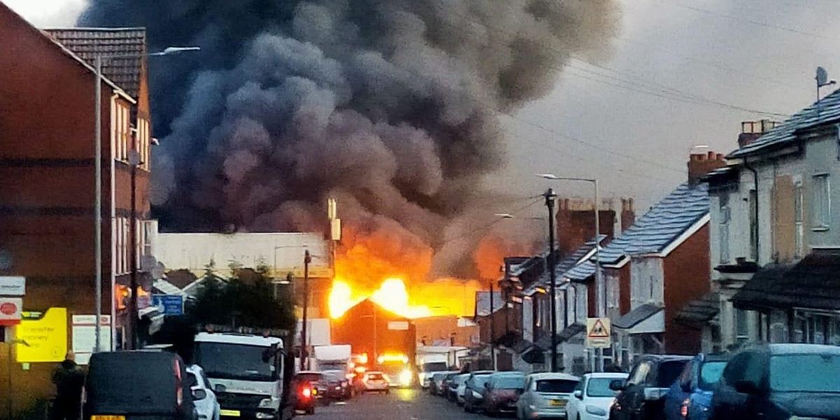 Huge inferno sends smoke billowing over city after 'explosions' heard