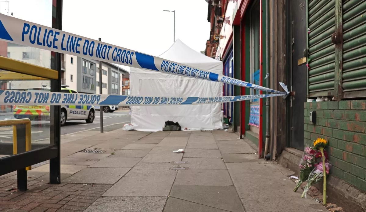 Police at the scene at Low Cost Food and Wine on Stanley Road in Bootle