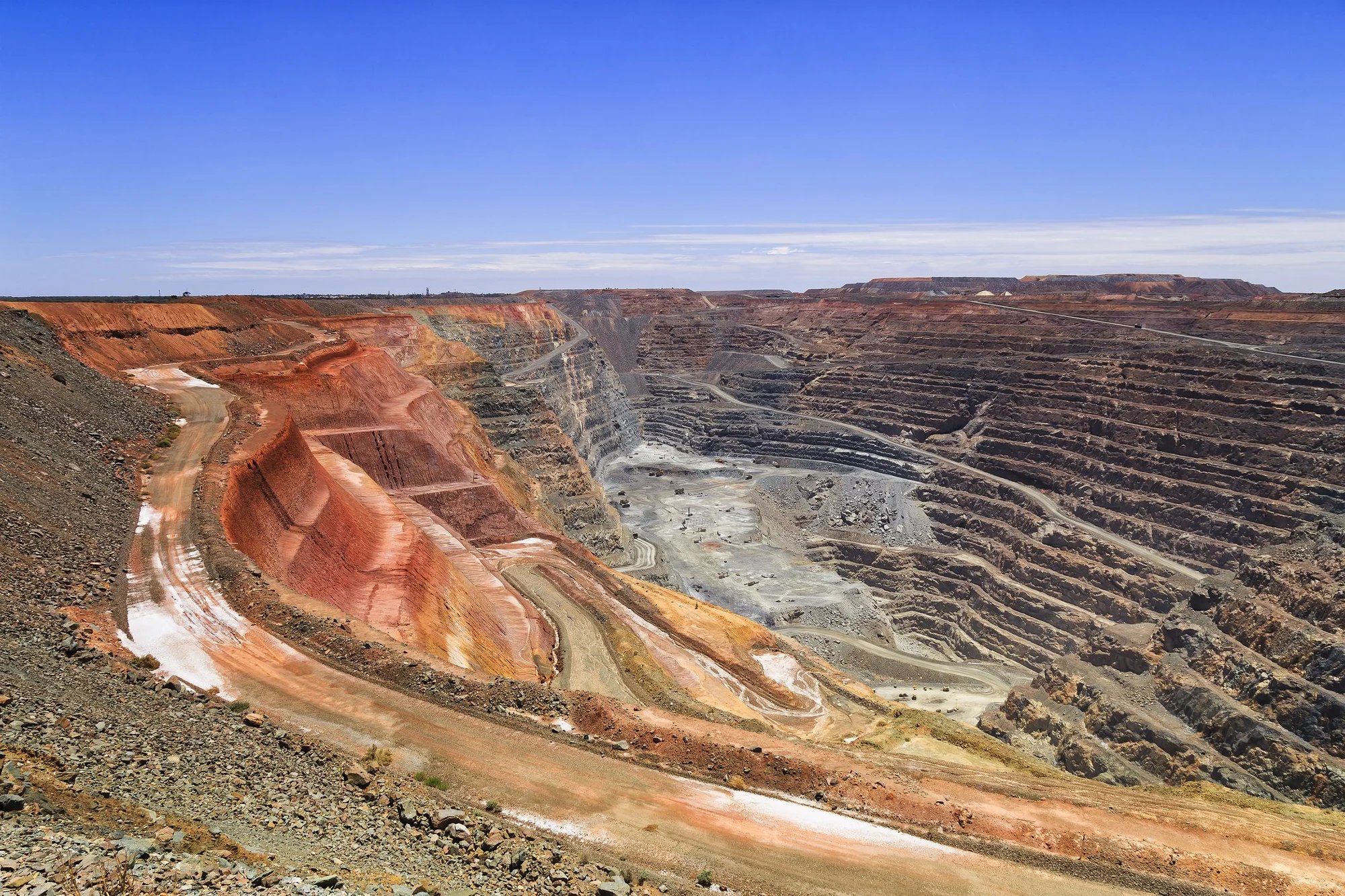 Mining shelves under a bright blue sky. 
