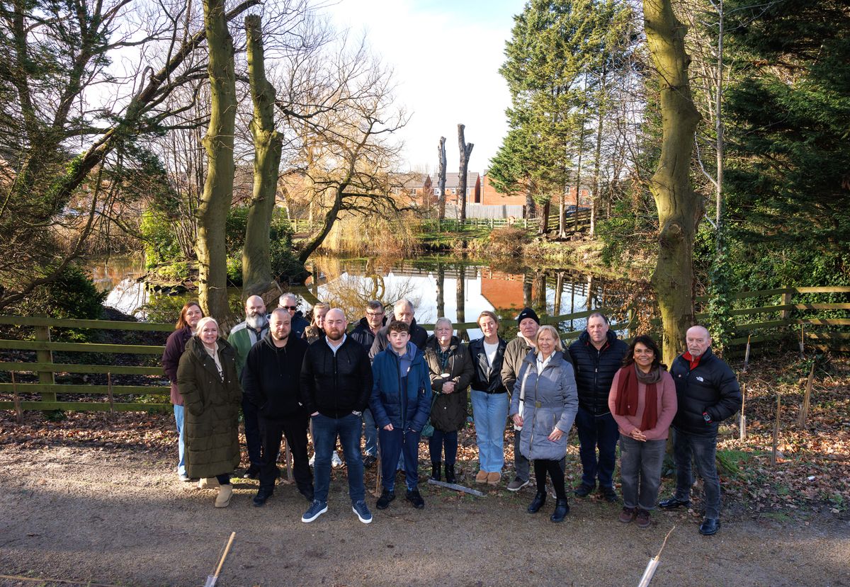 Local residents by the side of Moss Side Lake in the Poppy Fields estate, Maghull