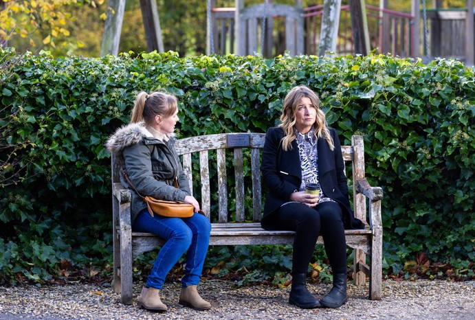 Vanessa stares at Charity, who looks off into the distance, on a bench in Emmerdale