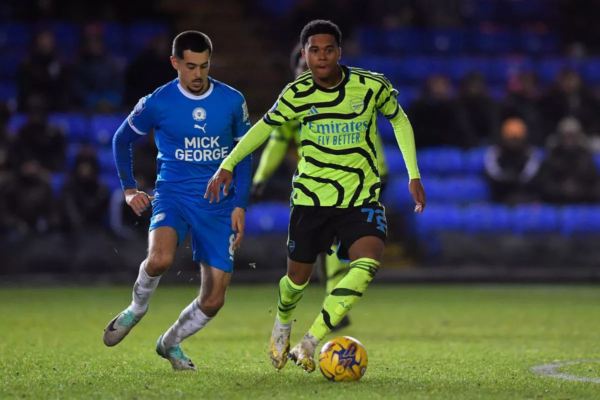 Arsenal under-21s left-back Lino Sousa is closed down by Ryan De Havilland of Peterborough United during the EFL Trophy match at the Weston Homes Stadium on December 5, 2023 - Photo by Alan Walter - Arsenal FC/Arsenal FC via Getty Images