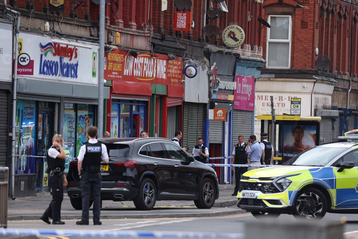 Police outside Low Cost Food & Wine in Bootle
