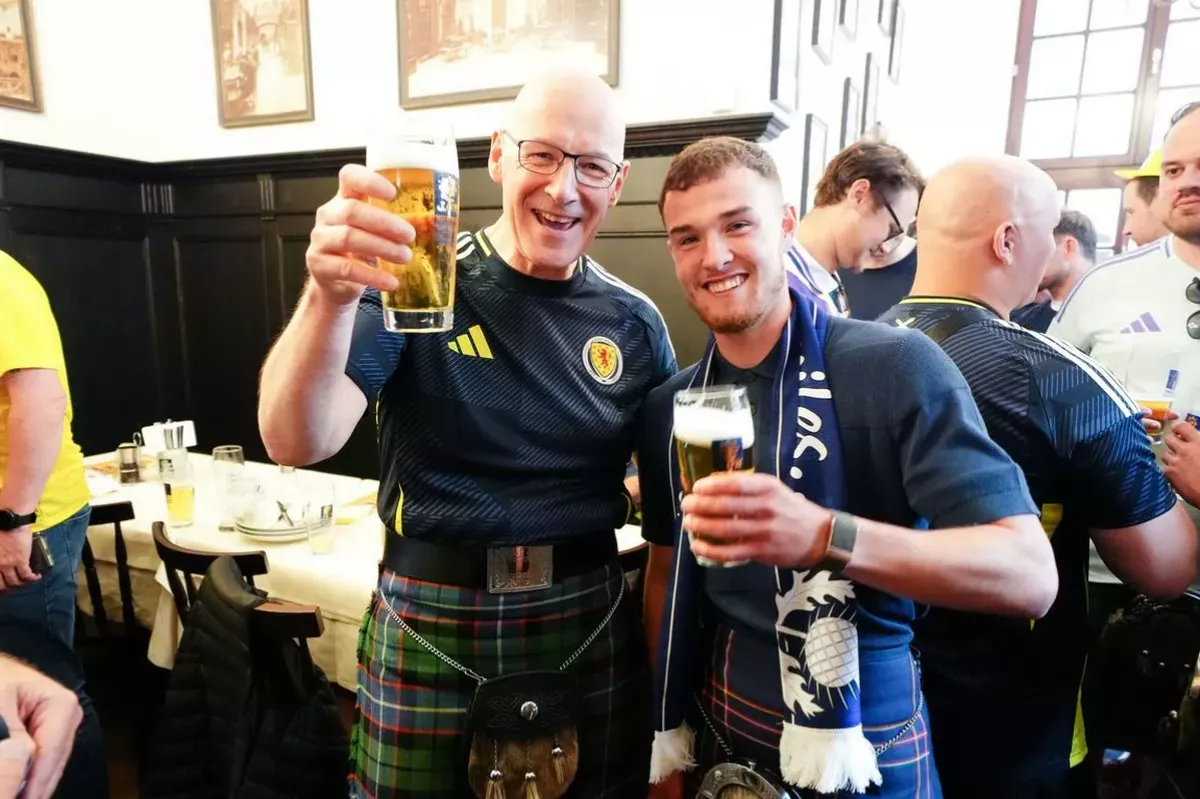 First Minister John Swinney enjoys a beer with Tartan Army fan Craig Ferguson (right) in Munich before the Germany v Scotland game at Euro 2024