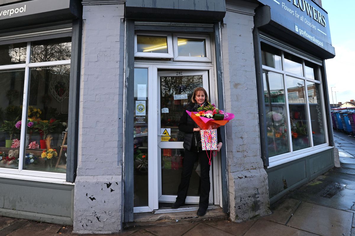 A woman stood outside a florists shop