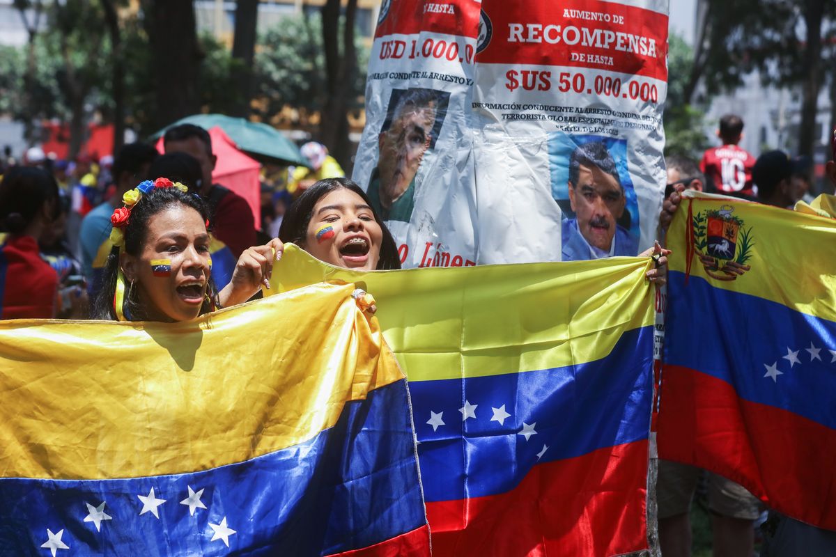 LIMA, PERU - JANUARY 3: Venezuelan citizens in Peru celebrate during a rally after the confirmation of Nicolas Maduro's capture this early morning in Caracas on January 3, 2026 in Lima, Peru. President Donald Trump announced that Nicolas Maduro and his wife, Cilia Flores, were captured in the early morning in Caracas after a military operation led by the Delta Force, the elite special missions unit of the U.S. military. (Photo by Mariana Bazo/Getty Images)