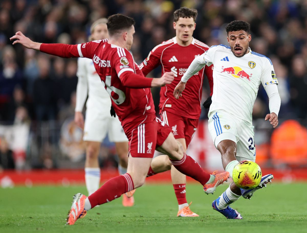 James Justin of Leeds United is challenged by Andrew Robertson of Liverpool during the Premier League match between Liverpool and Leeds United at Anfield on January 01, 2026 in Liverpool, England