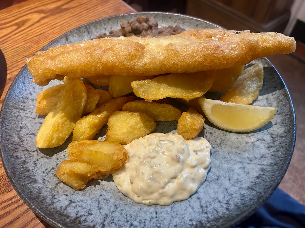 Battered haddock, triple cooked chips, black peas and tartare sauce 
