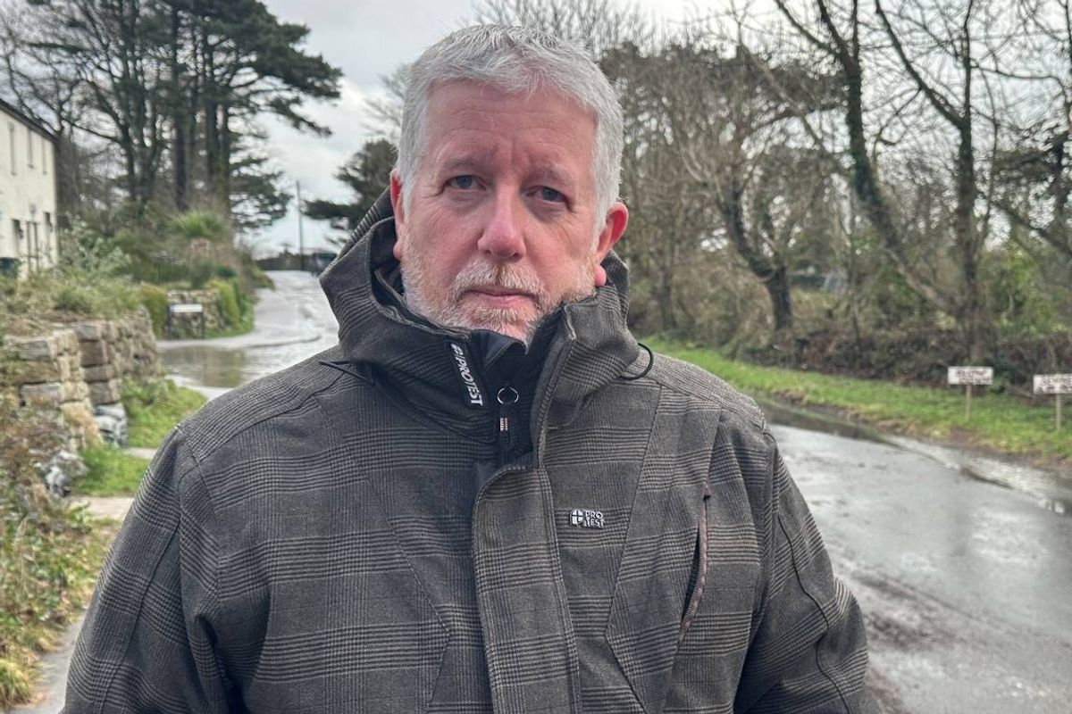 Andy Snapes, a resident in Stithians who has been vocal against SWW's lack of action, outside the 'lake of poo' on Hendra Road at the top of the village 