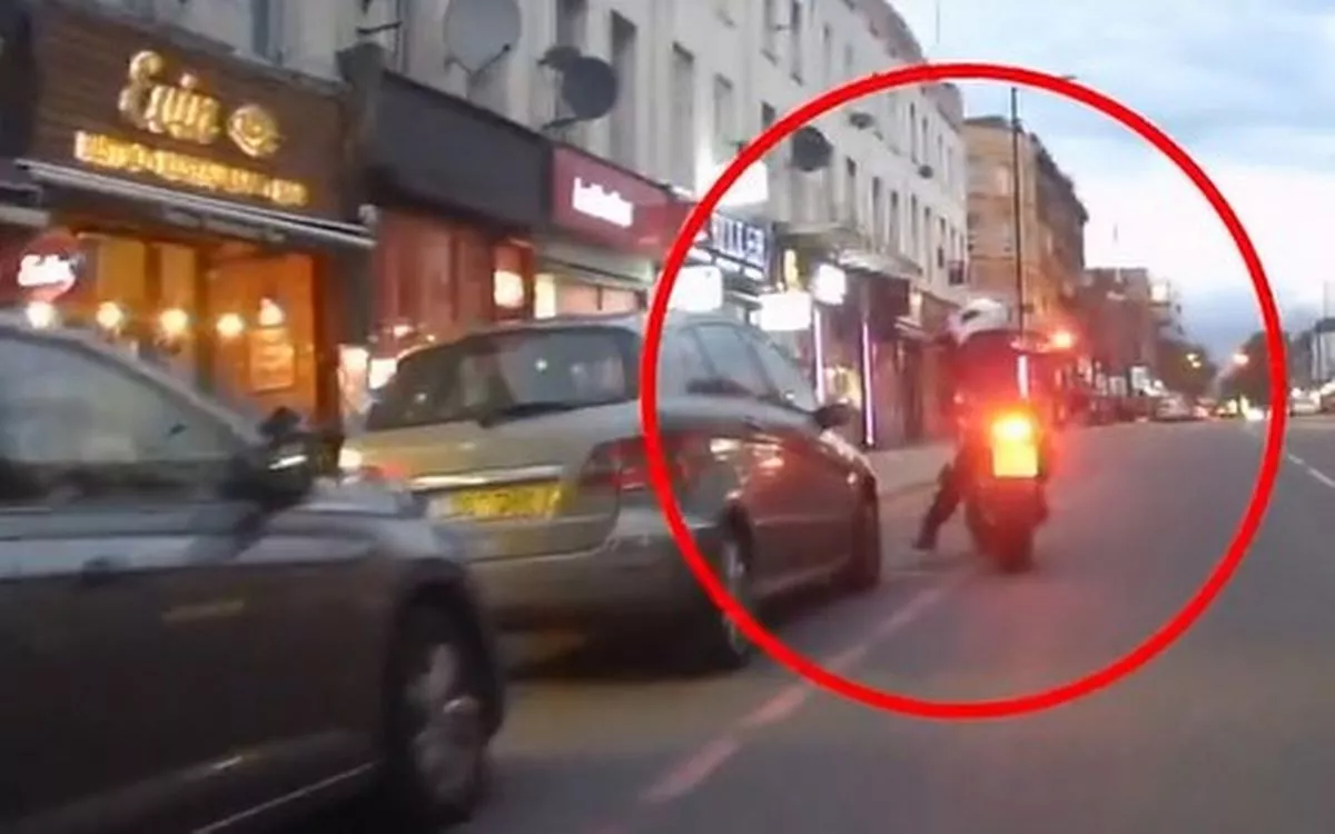 Picture issued by the Met Police of the gunman on a moped in a street in Dalston, east London