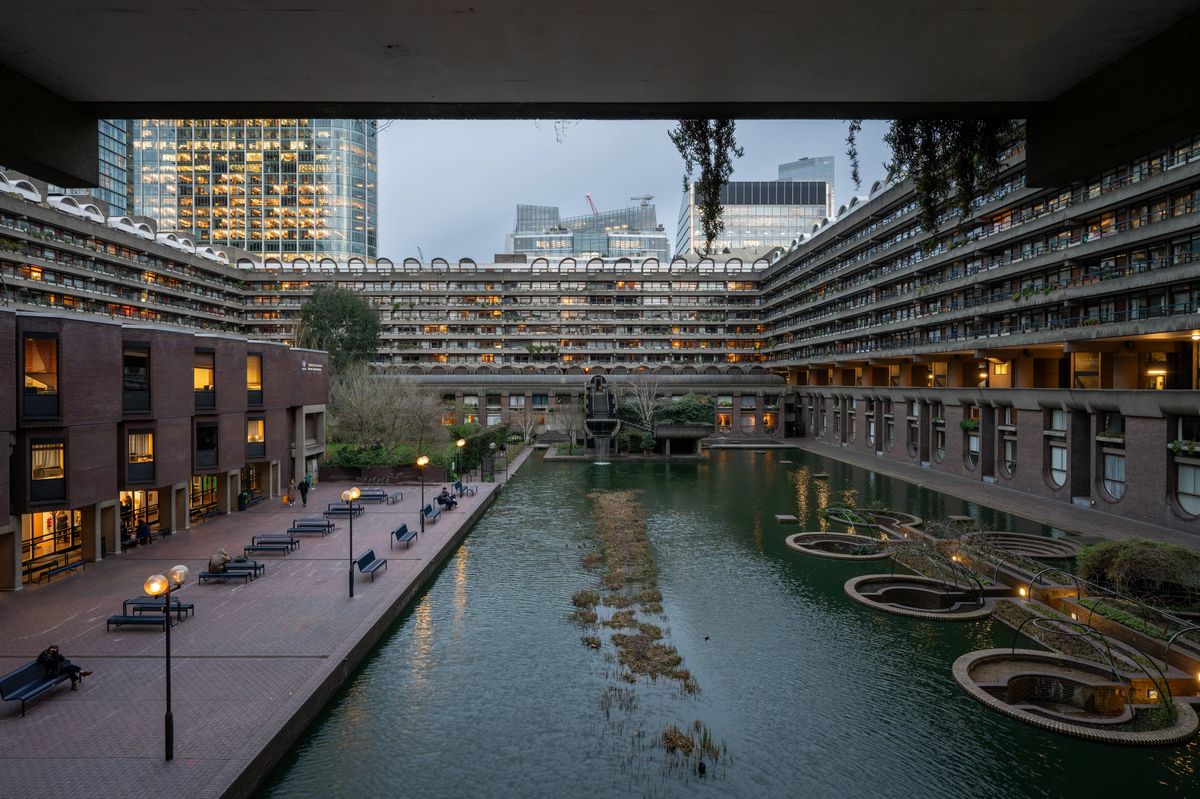 London, UK: Artificial lake with waterfall on the Barbican Estate in the City of London. The Barbican Estate is a prominent example of Brutalist architecture in London.
