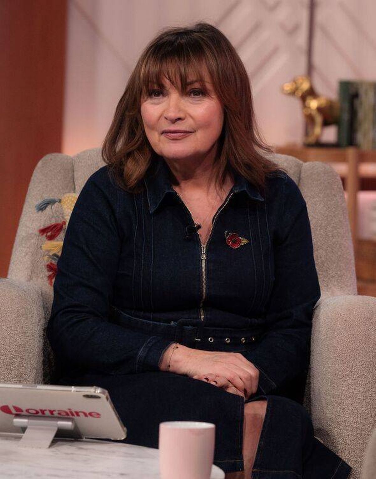 Lorraine Kelly sitting in a chair on the set of her show