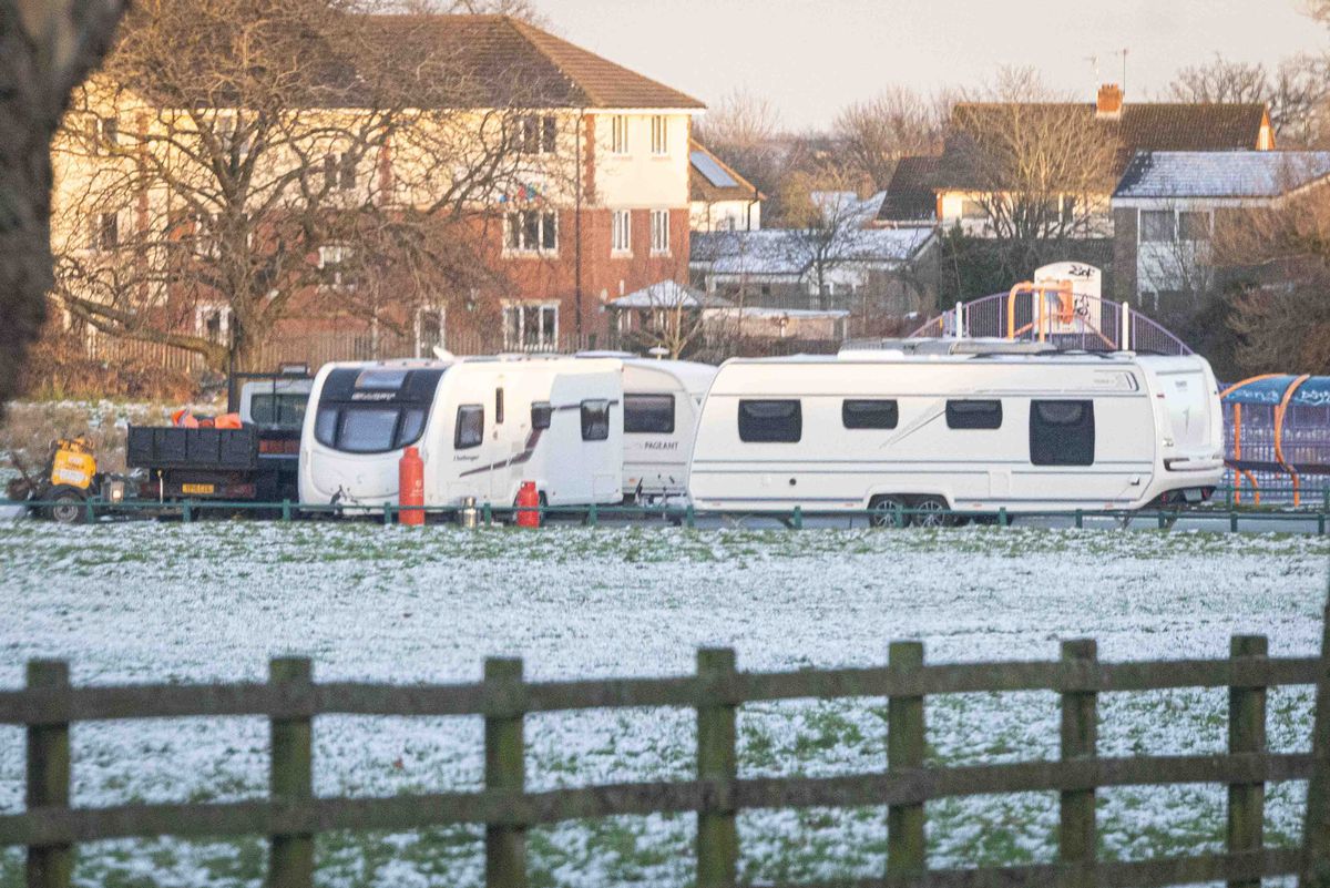 A group of travellers on the car park of Daisy Farm Recreation Ground, Maypole Lane