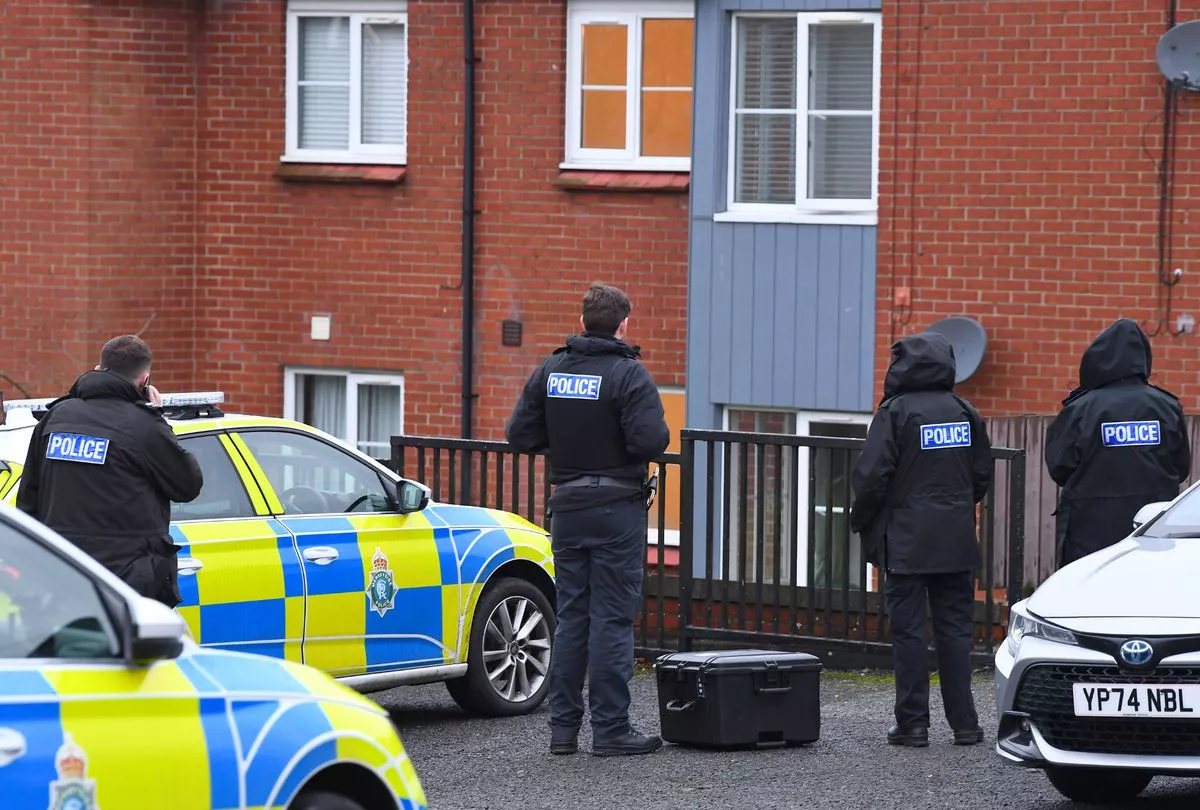 Officers stand outside Gerards Court. 