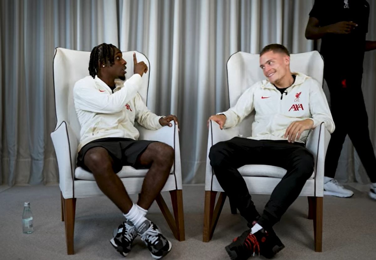 Jeremie Frimpong pointing at Ibrahima Konate while Florian Wirtz sits in-between and laughs