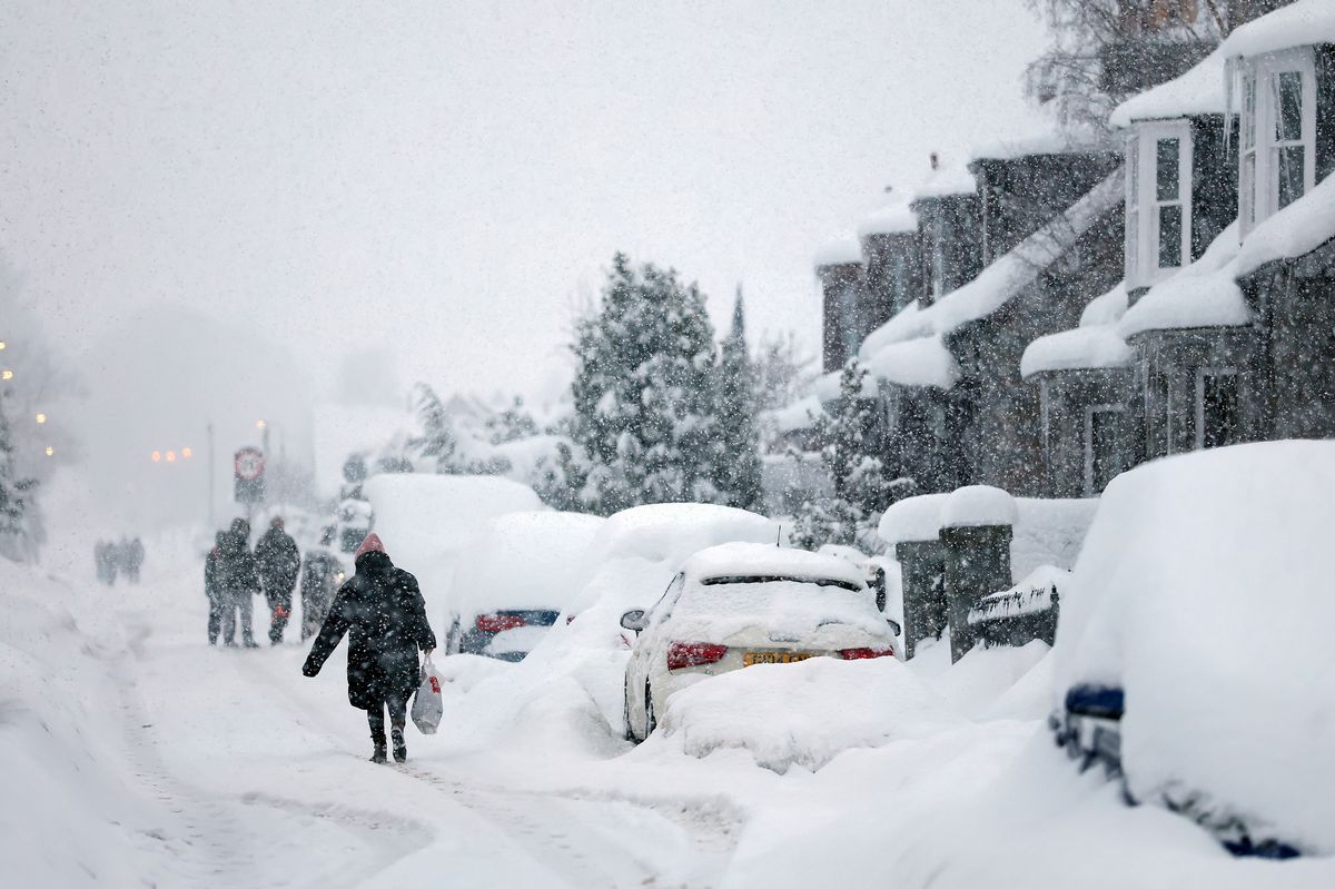 People walk in Main Street Alford as Aberdeenshire Council declared a "major incident" as snow continues on January 06, 2026 Alford, Scotland