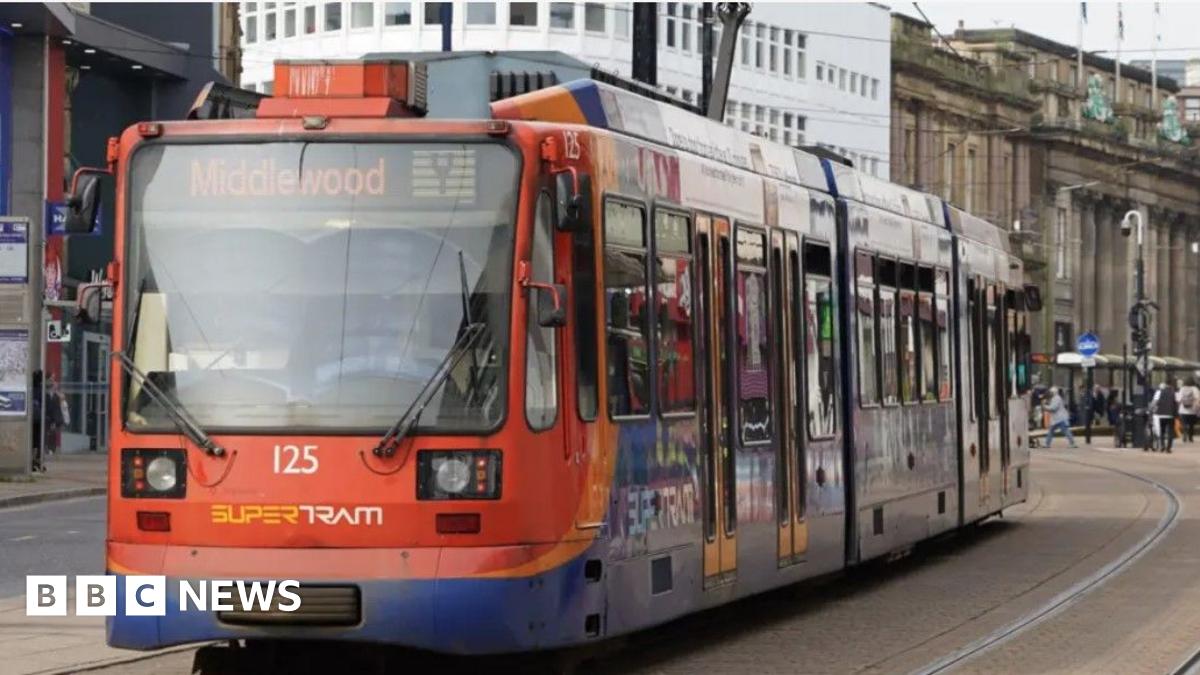 Sheffield Supertram heading up High Street towards Middlewood from Sheffield city centre with Fargate and Cutler's Hall to the left