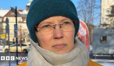 Lena, wearing a scarf and a turquoise hat