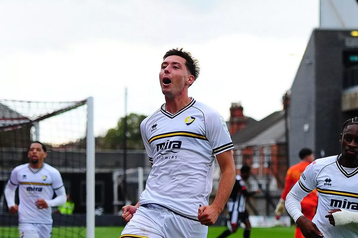 Isaac Hutchinson celebrates a goal for Cheltenham Town