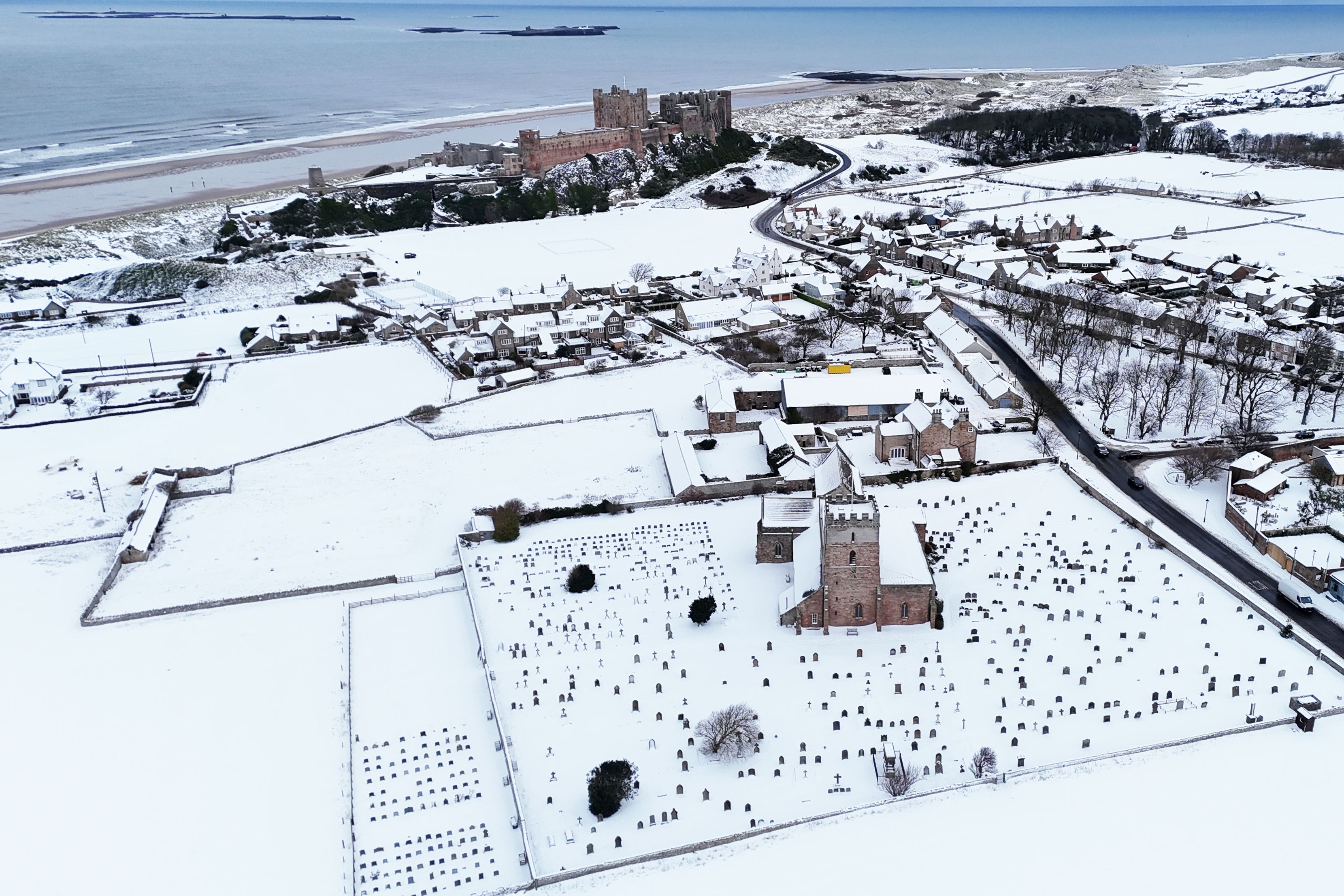Bamburgh Castle surrounded by snow in Bamburgh, Northumberland