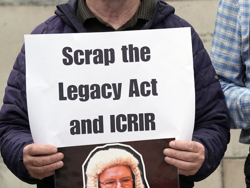 A protester outside the Royal Courts of Justice in Belfast, where judgment is due in September 2024