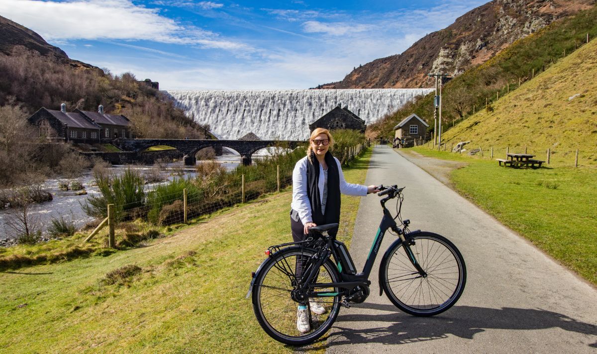 A woman and a bike in a scenic location