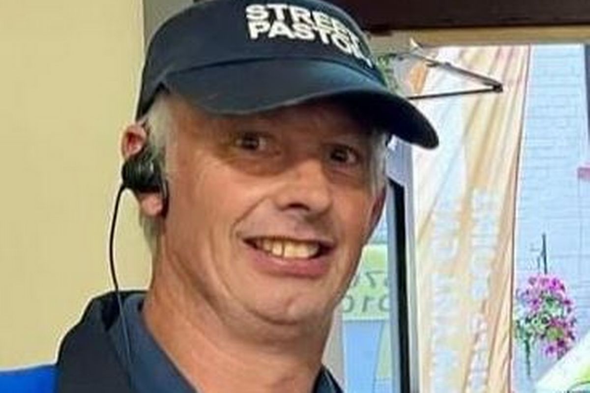 A man smiling in a hat