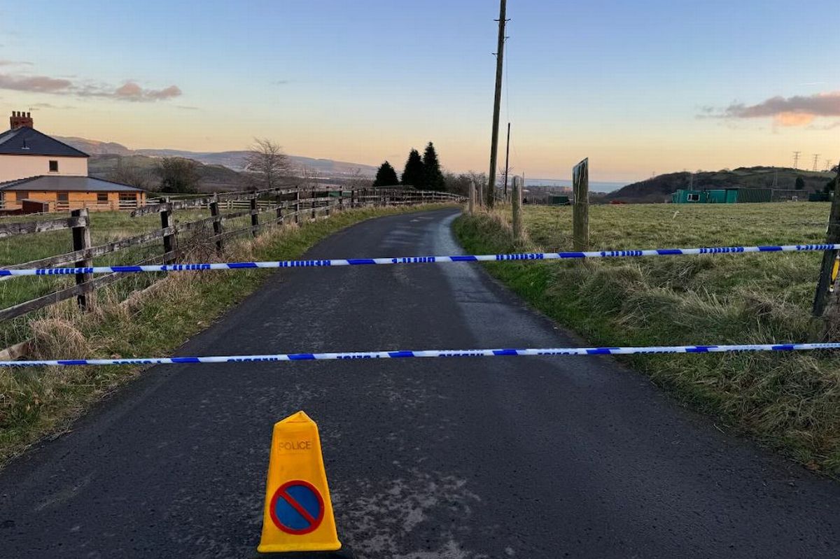 A road with police tape blocking it