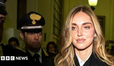 Chiara Ferragni is surrounded by press holding cameras and microphones as she  arrives at a courthouse in Milan.