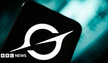 A black and white logo on what looks like a mobile phone.